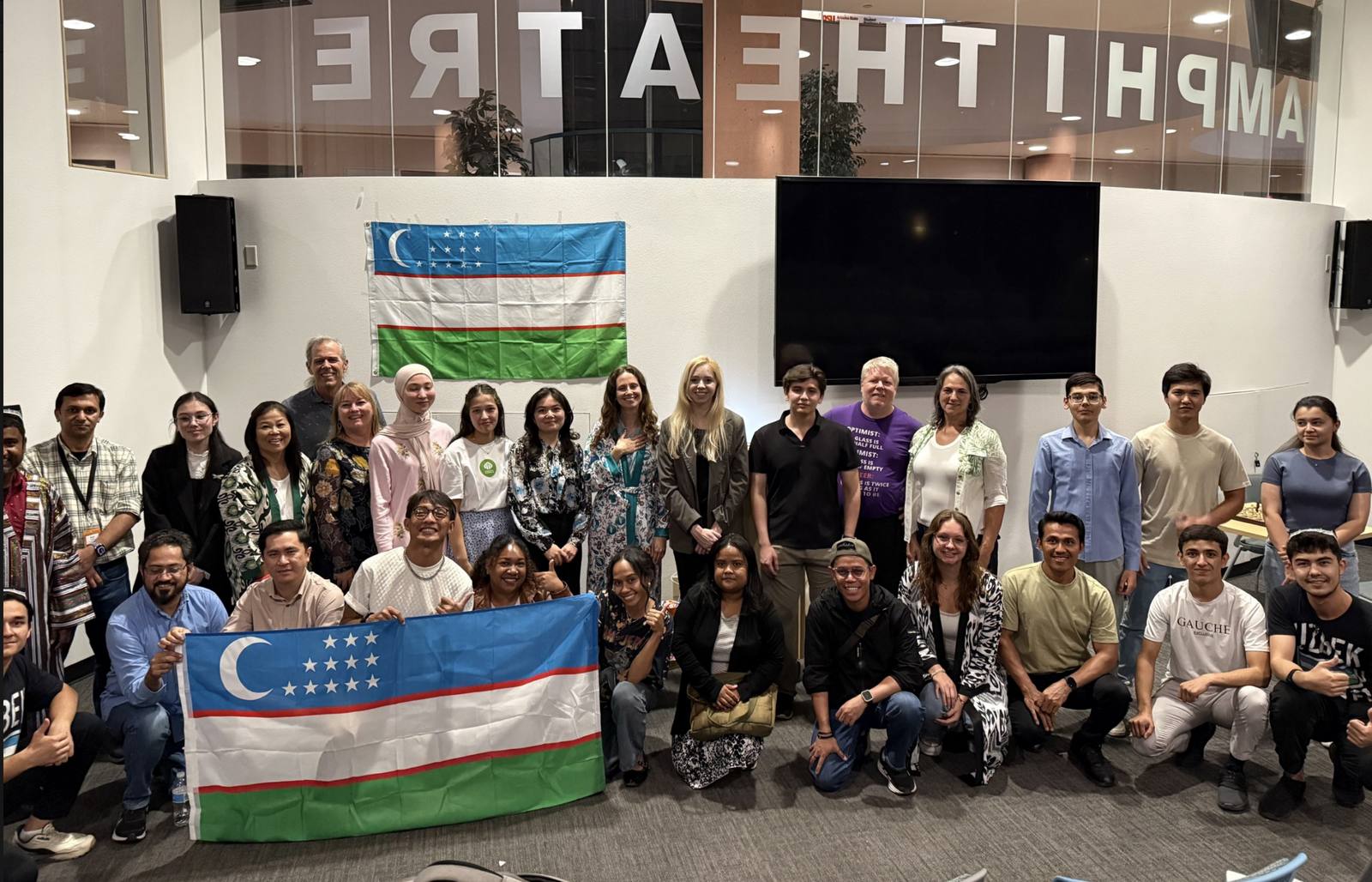 Students holding the Uzbek flag at Uzbek Cultural Day at ASU